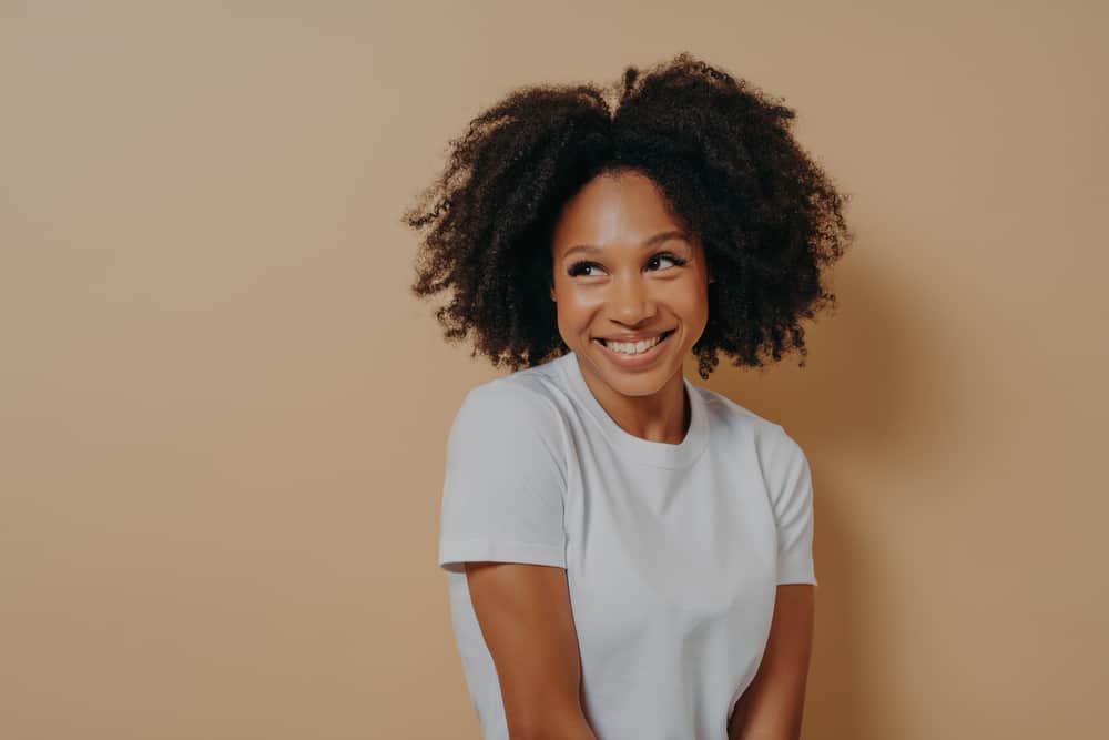 Black girl with a fresh cut who is worried about whether her hair will flick outwards.