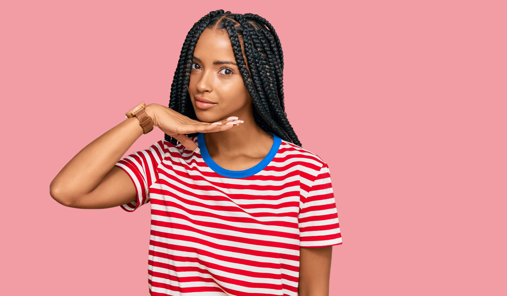 A black lady wearing a braided style that's central to many African cultures, like Ghana braids in Ancient Africa.