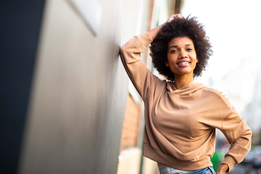 Black girl wearing her curly natural hair in a wash n go style created with hair products with hydrating ingredients.