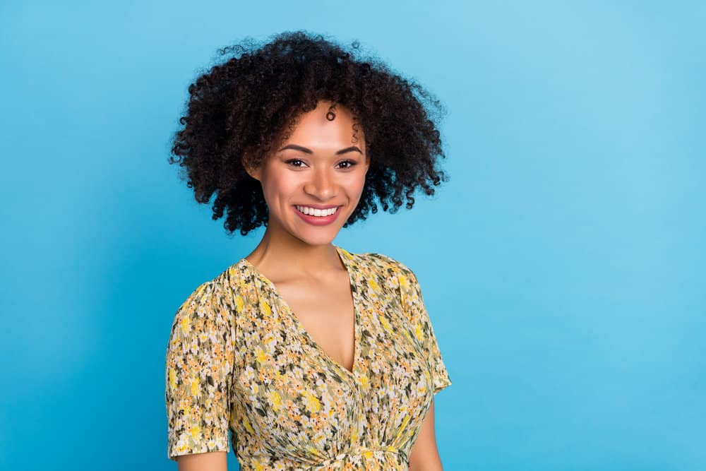 A lovely young lady with stiff hair after using a pre-shampoo treatment and leave-in conditioner.