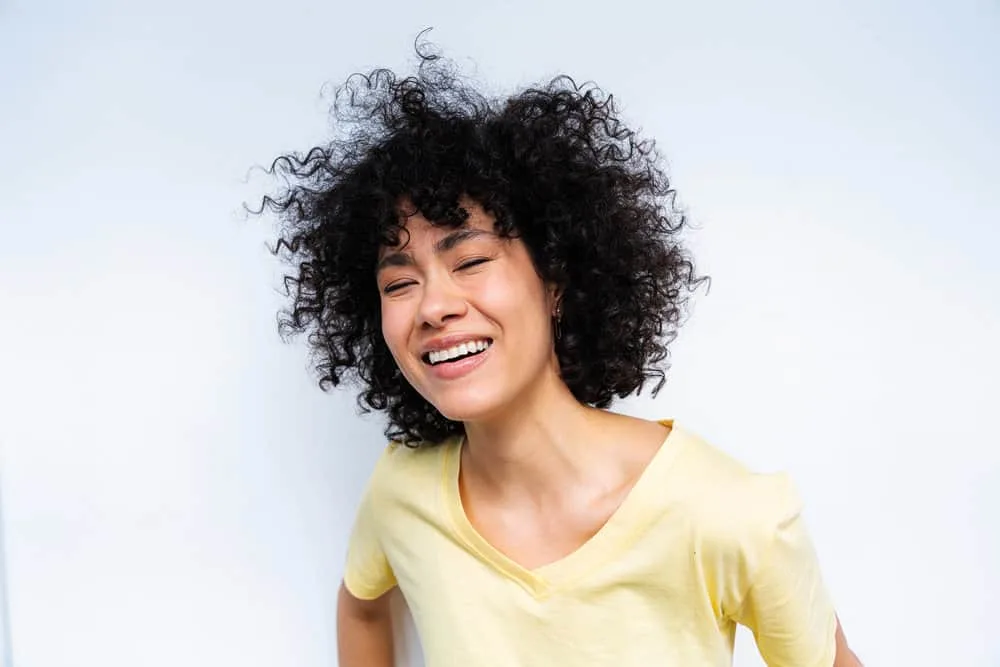 Does Rice Water Expire? Can You Use Old Rice Water? 3 Young lady with perfect skin and bouncy curls after using skin toner and styling her hair with rice water ice cubes.
