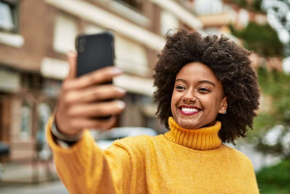 A young black girl with dark hair wants to blend grey hair with a dark brown color because she's growing gray hairs.