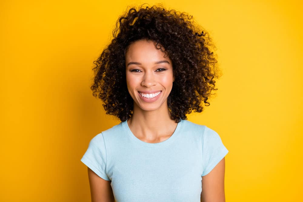 Gorgeous African American female with dark brown bleached hair includes natural and artificial pigments.