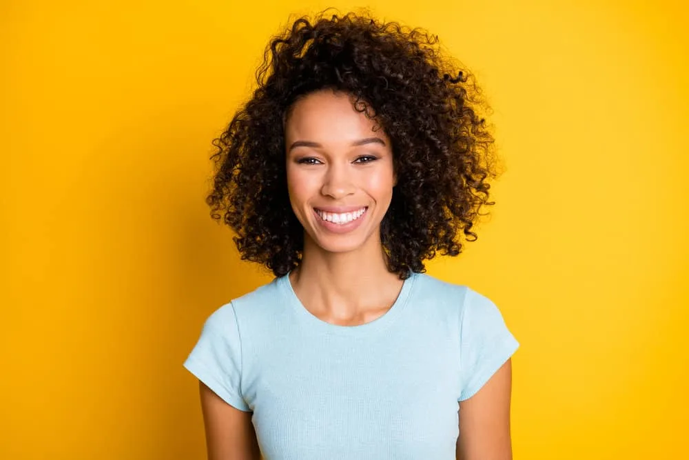 Can You Bleach Over Semi-Permanent Hair Dye? What Happens? 1 Gorgeous African American female with dark brown bleached hair includes natural and artificial pigments.