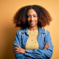 Cute young African American female with permanent hair color on her unwashed hair strands.