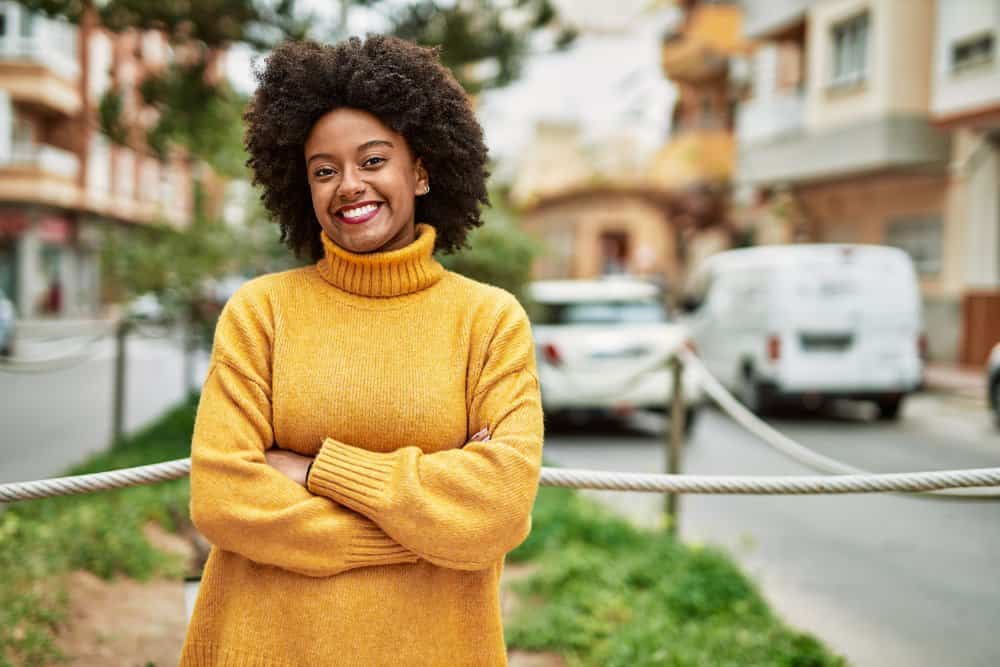 A lovely young black lady with dark hair wants to dye her curls a dark brown color since she's turning gray.