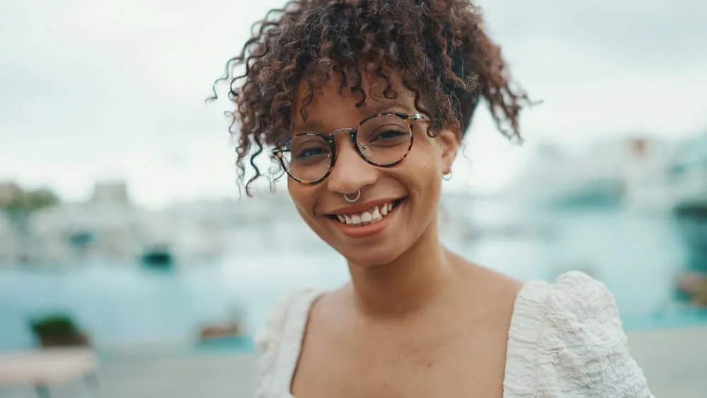 A young female with natural curls saw her own hair change from stick straight to super curly as she got older.