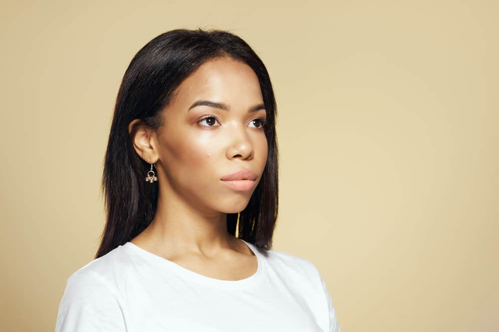 A young light-skinned girl after blow-drying her color-treated hair with hot tools.