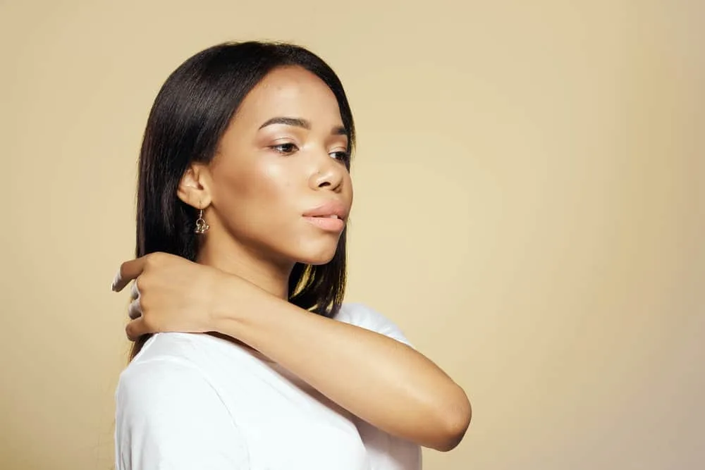 How Long Does Heat Protectant Last on Hair After Applying It? 6 A young, light-skinned African American girl with dry hair after flat ironing her wet hair.