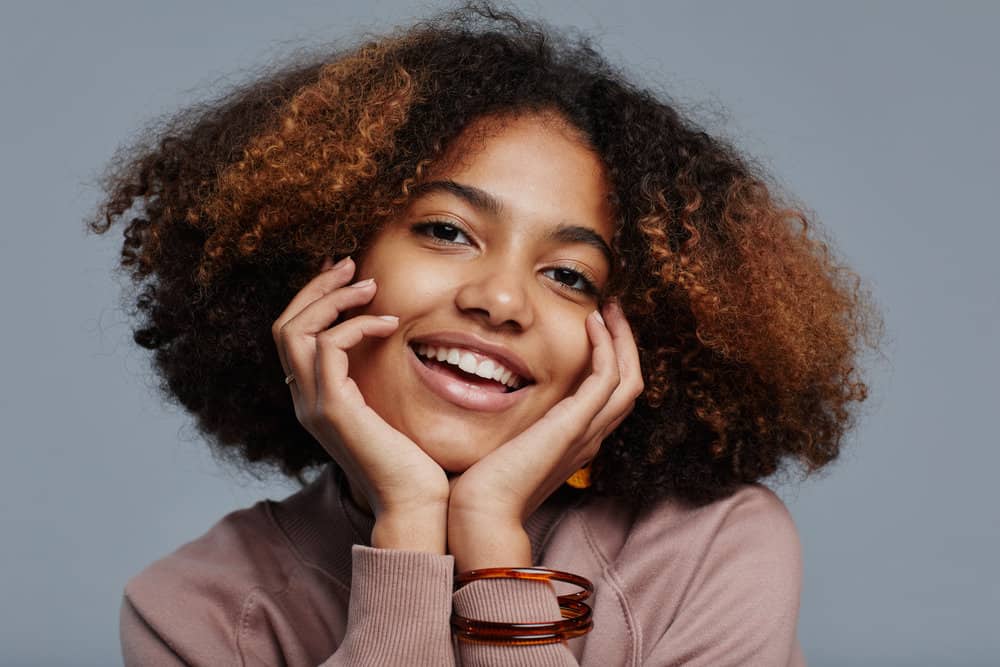 African American female with black and brown curly hair after using Prose shampoo and conditioner.