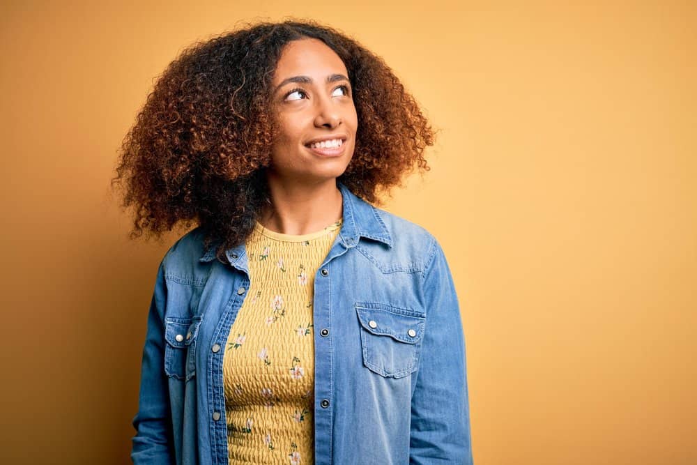 Young lady with a unique dark brown and black hair color after mixing permanent hair dyes.