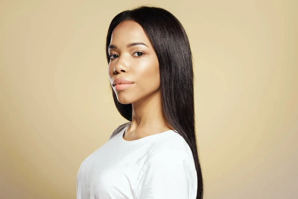 How Long Does Heat Protectant Last on Hair After Applying It? 7 Confident black woman after straightening her hair with the best heat protectant spray.