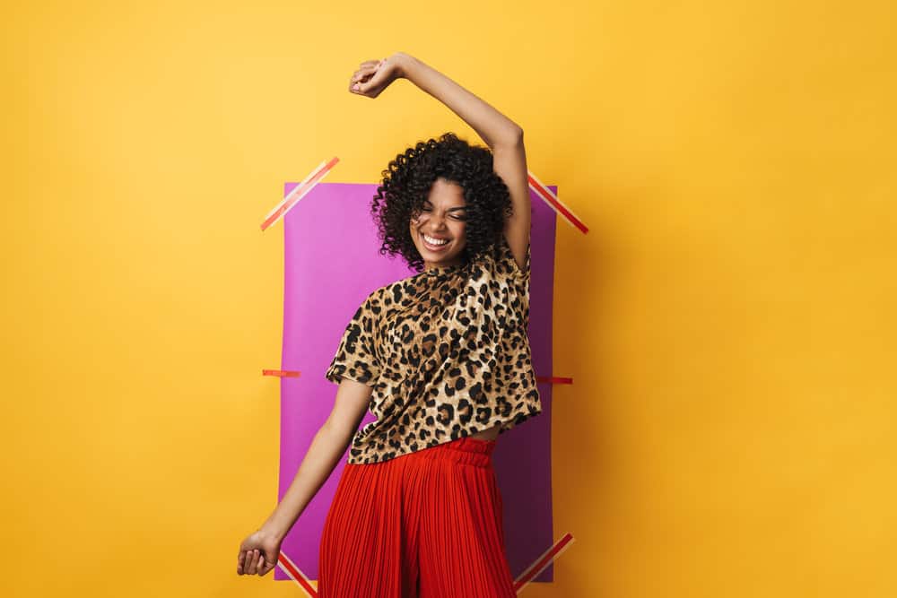 Pretty young black girl with bouncy curls styled with natural remedies available at most health food stores.