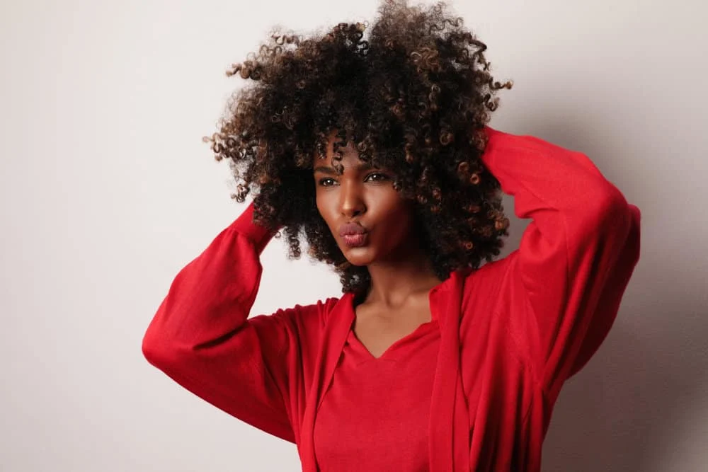 A young black woman whose hair smelled good after having it styled and treated at a local hair salon.