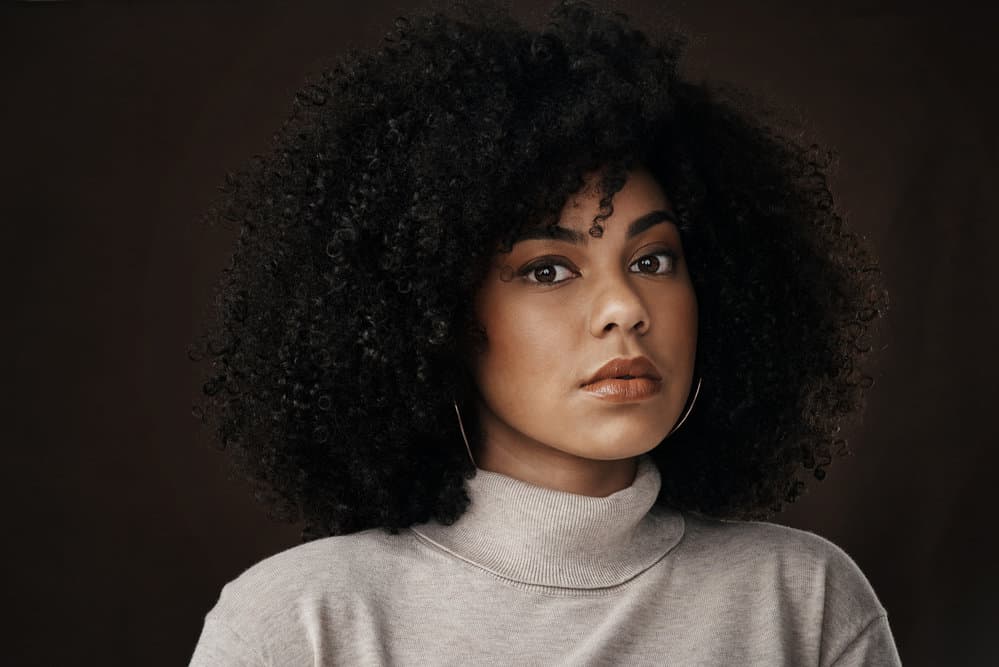 Young African American female after washing her hair with baby shampoo showing off her beautiful curls.