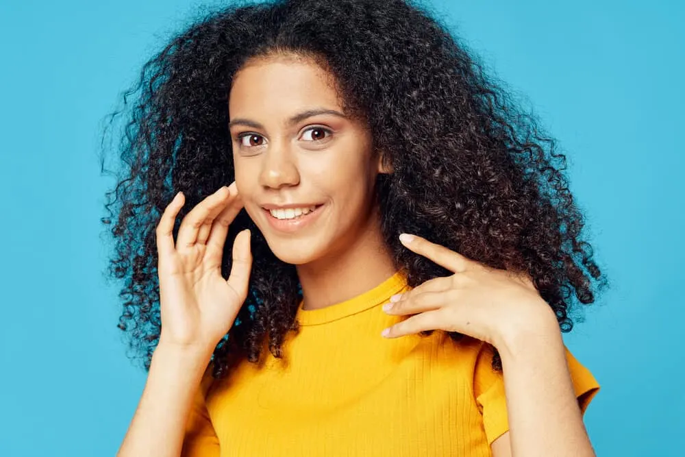 African American lady with improved hair health after suffering from stress-related hair loss.