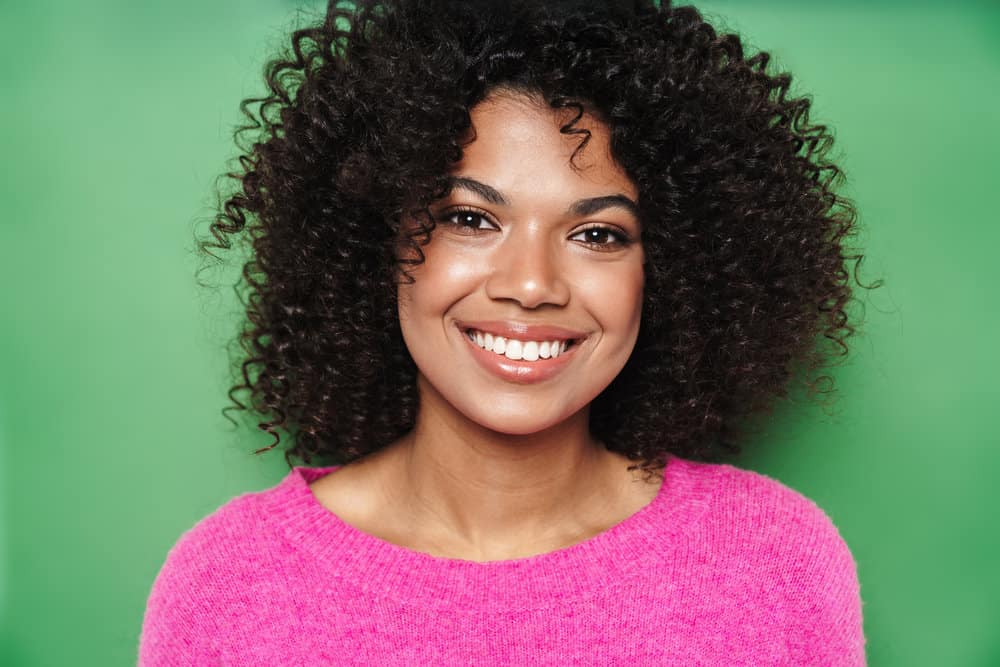 Cute young black girl with an underlying skin condition on her scalp making dandruff worse.