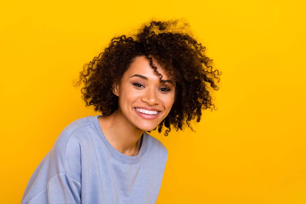 A cute black girl with a curly curl pattern after using the original recipe from Cardi B's famous hair mask.