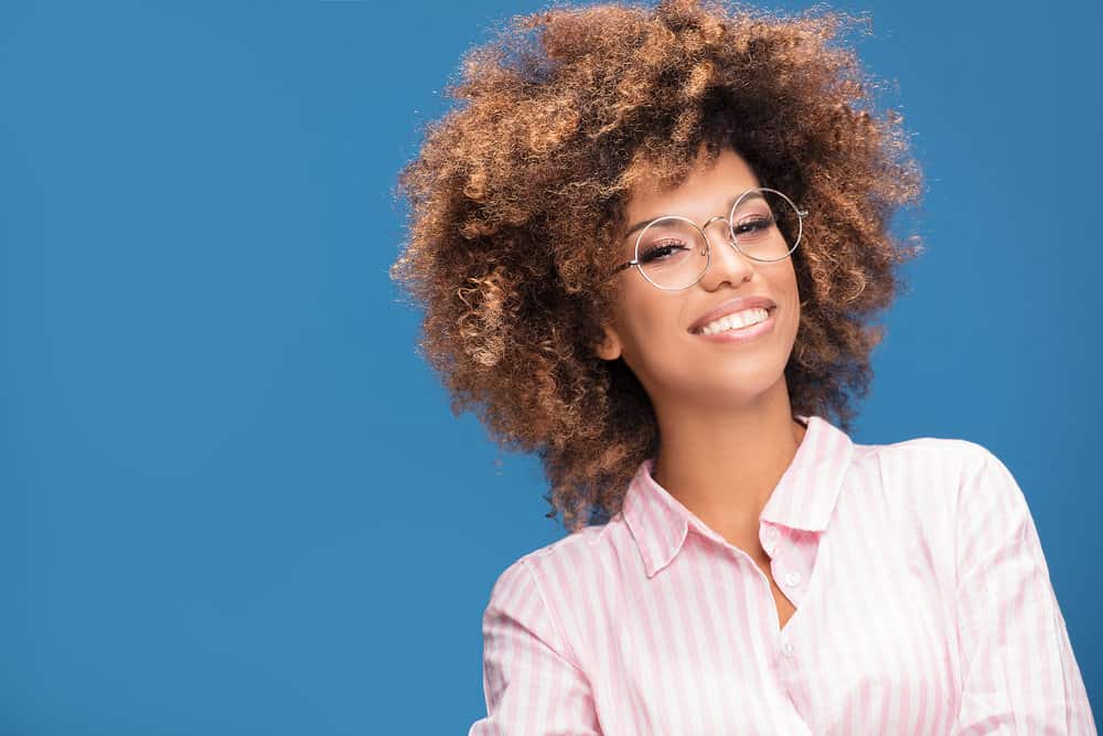 A lovely black girl after utilizing hair dye remnants kept in a dye tube within an airtight container.