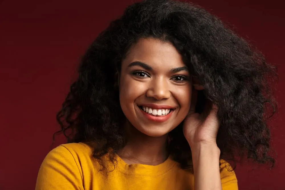 Why Won’t My Hair Stay Straight After I Straighten It? 8 African American lady decided to straighten hair with coconut oil to keep her curly hair healthy.