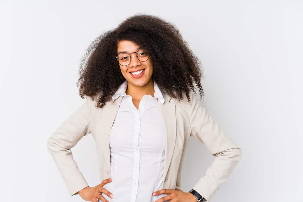 Young African American businesswoman with long hair wearing her curls loose creating a professional look.