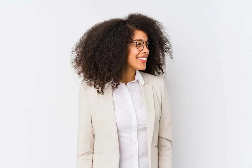 Is Curly Hair Professional or Unprofessional? Best Workplace Styles 2 Black lady with kinky hair wearing long curls - one of our favorite natural hair styles for African American women.