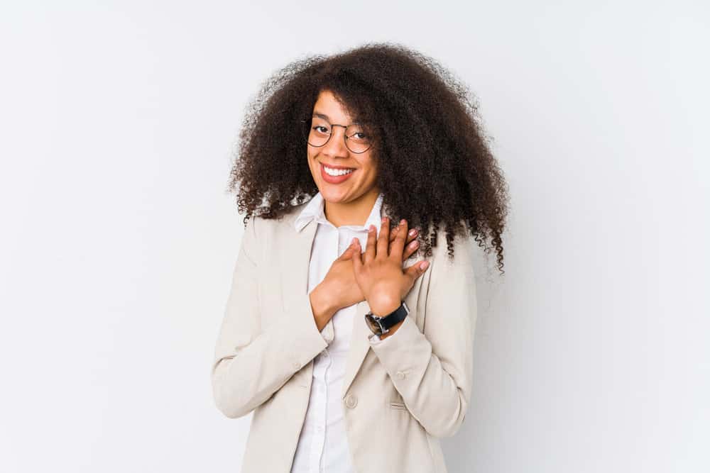 Young black girl that gave up hair cuts a few years ago to create the perfect middle back length curly hairstyle.