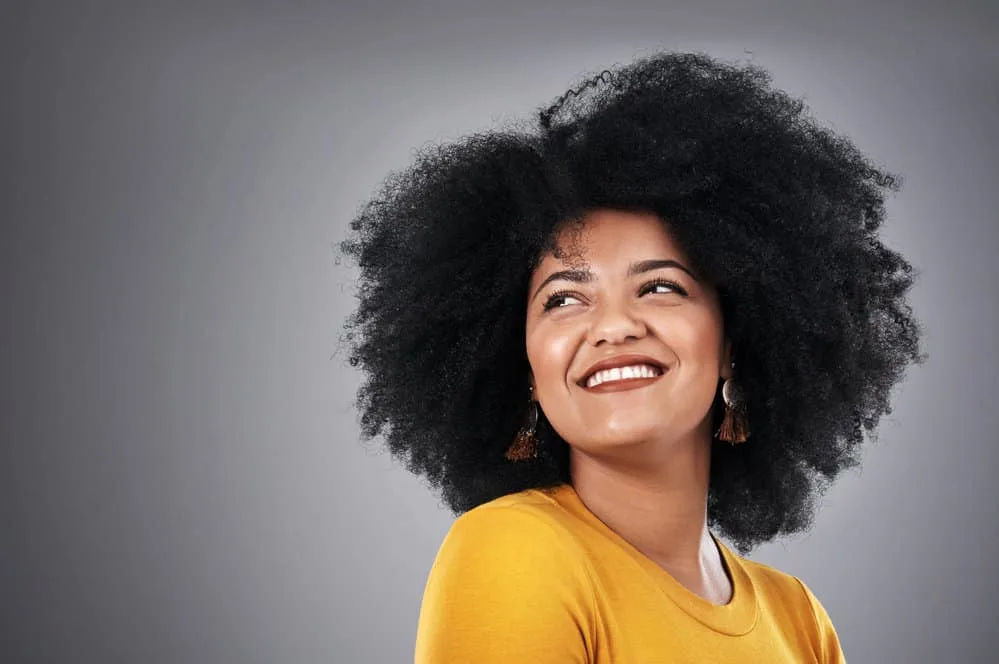 Why Is My Black Hair Turning Gold? 4 Causes & 3 Quick Fixes 3 Cute young light-skinned female with light brown natural hair turning gold due to brown eumelanin cells.