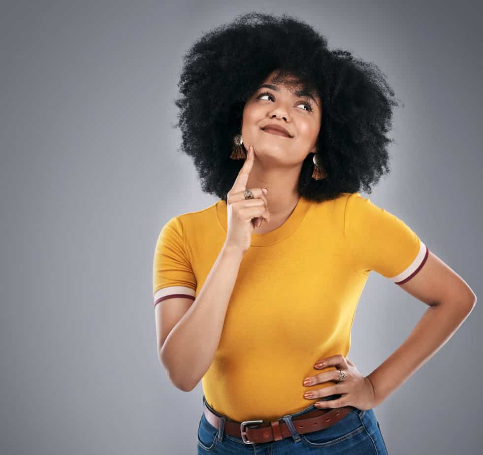 A beautiful girl with melanin pigment in her skin hair's turning golden after using hair products with harsh chemicals.