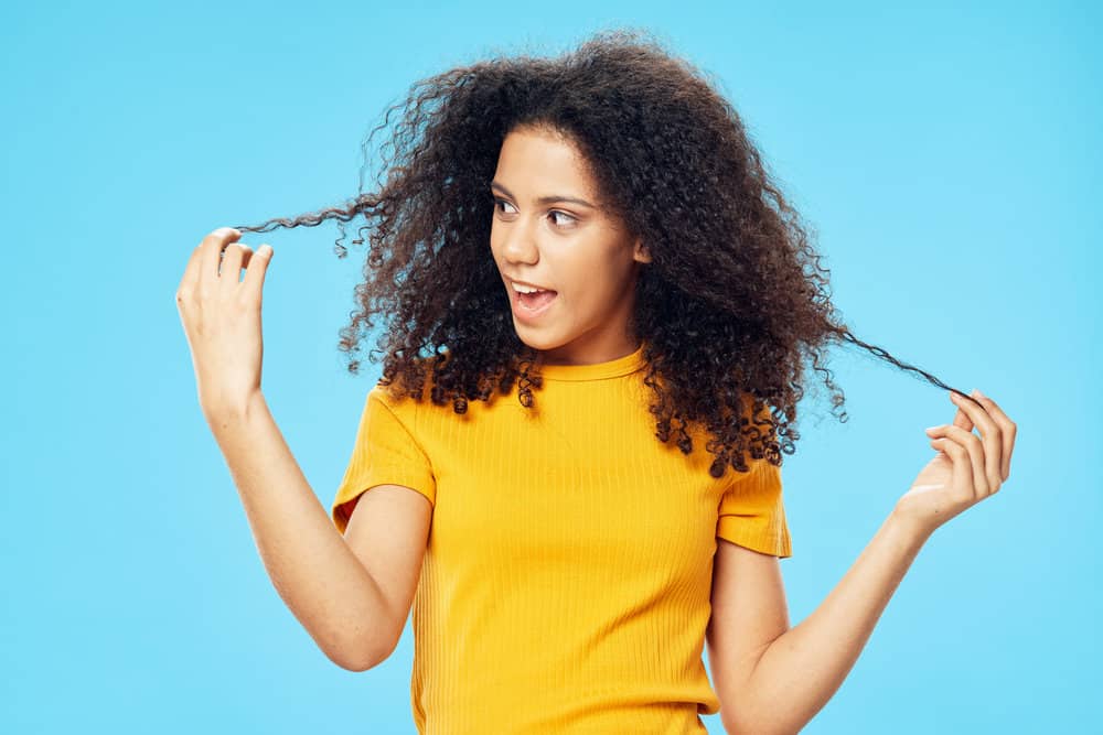 A young light-skinned black woman with color-treated hair suffered from female hair loss before using Prose shampoo.