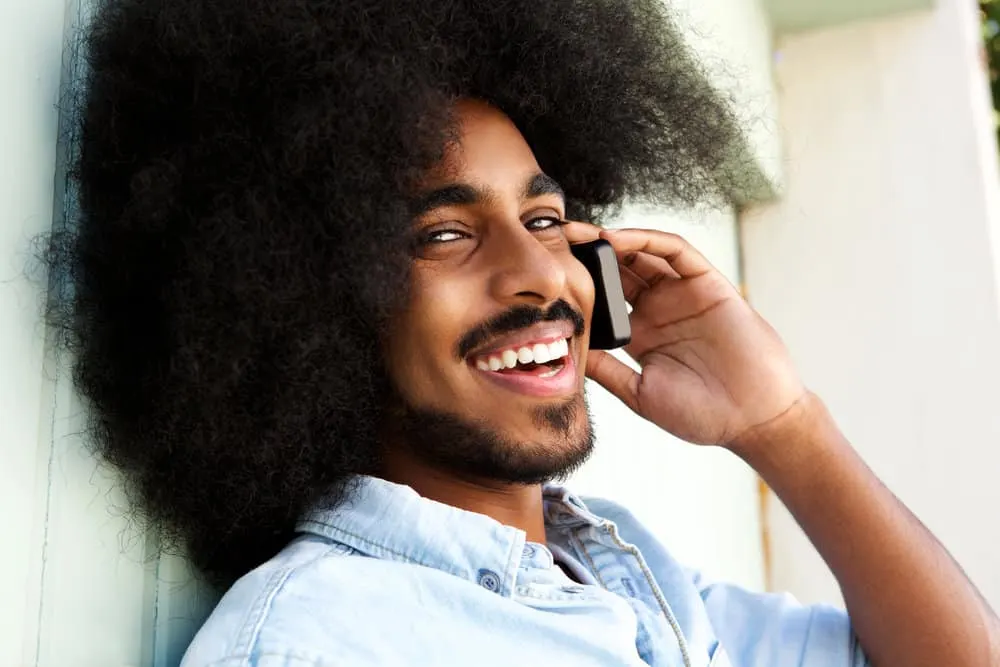 What Long Hair Says About a Man? What Does It Symbolize? 8 A young guy who's a metal head asking his girlfriend if she likes rock bands during a phone call.