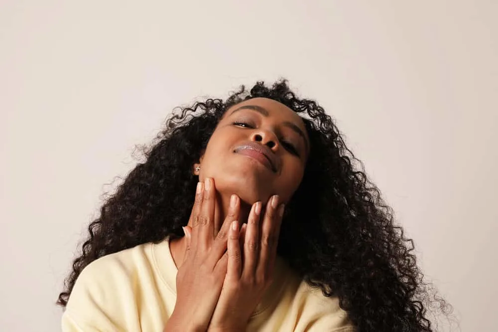 Does Prose Work for Curly Hair? Is It Curly Girl Approved? 7 Beautiful African American woman with shiny hair after using Prose shampoo and two hair masks for low porosity hair.