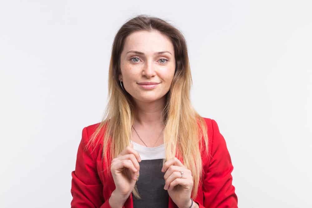 Young woman who has her own loose hair, rather than wearing a hair covering like divorced and widowed women.