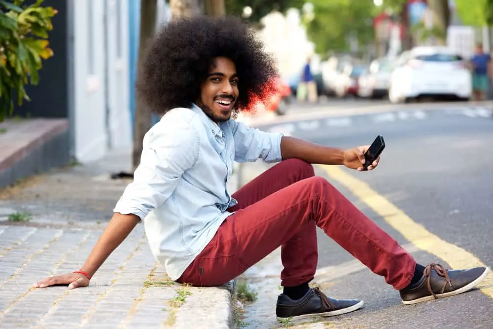 What Long Hair Says About a Man? What Does It Symbolize? 7 Happy young black dude wearing casual clothes as he prepares to take his date onto the dance floor.