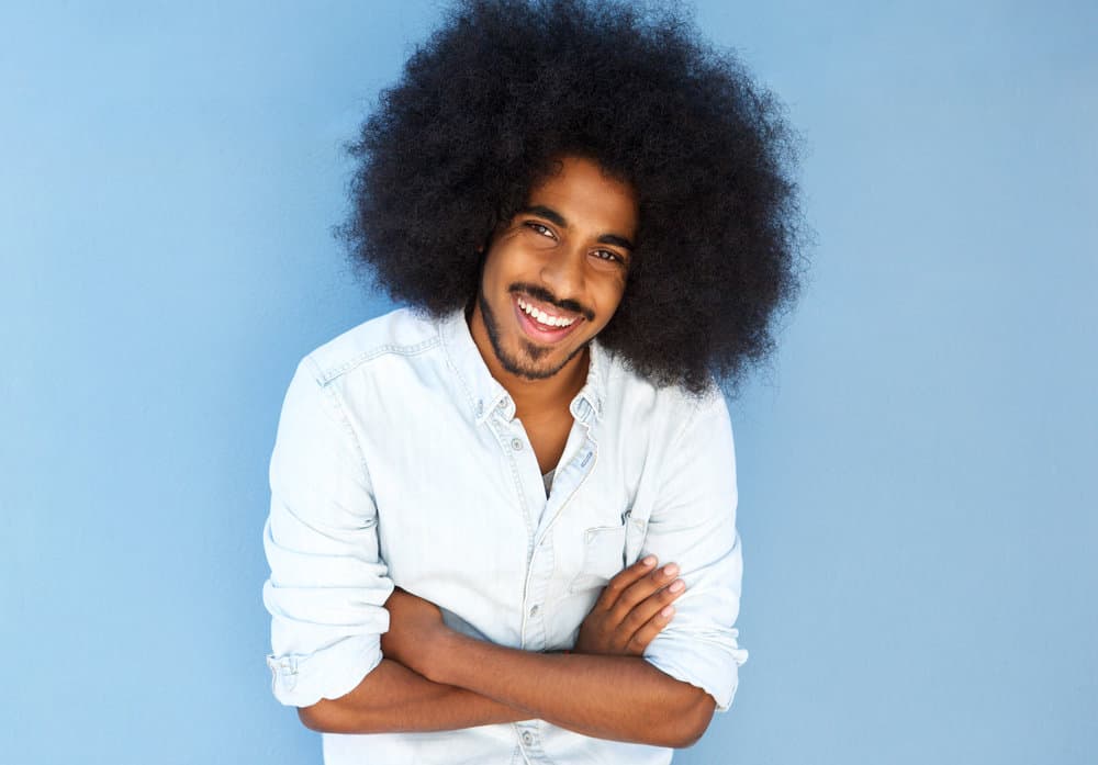 African American dude with an afro wearing a low maintenance style that garners much attention.