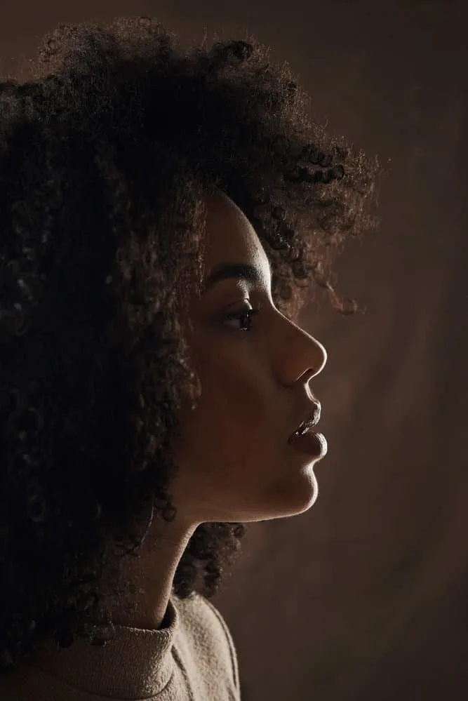 How Do You Clean Lint Out of a Hairbrush: Step-by-Step Guide 8 This gorgeous woman has short curly hair that she has styled with a wide-tooth comb.