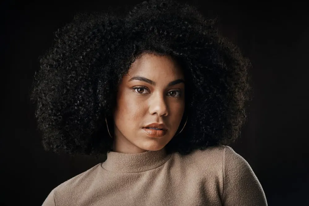 After washing her hair with baby shampoo, this beautiful young black woman is showing off her gorgeous curls.