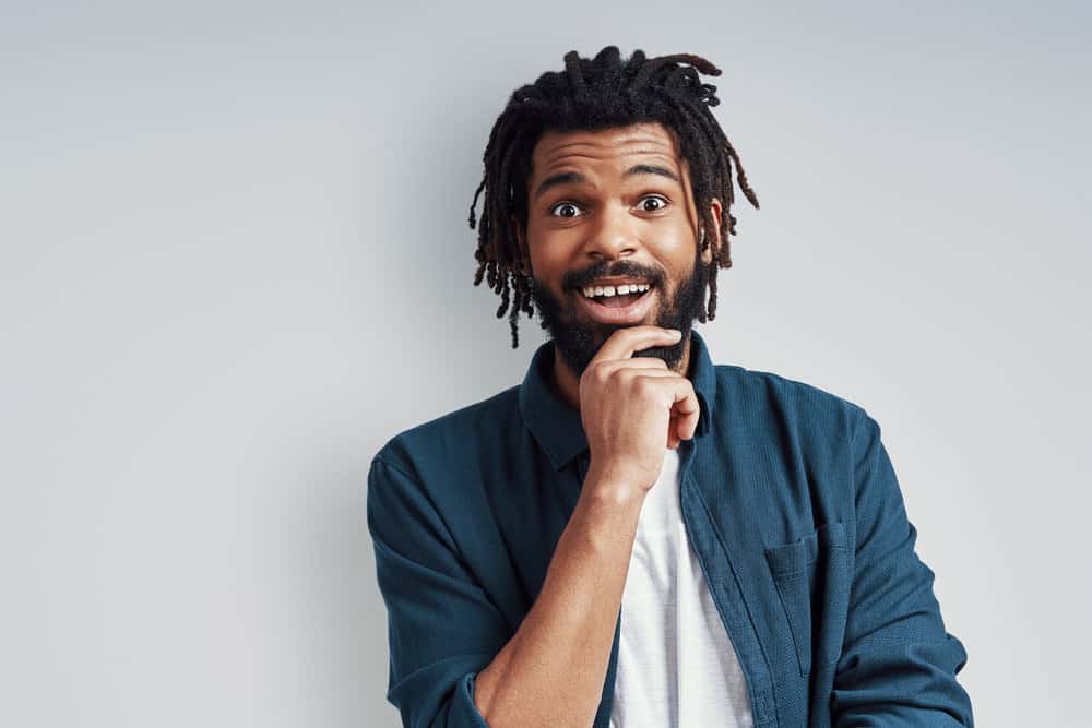 African American man with a 4B hair type suffering from dreadlock dandruff and needing an antifungal shampoo.