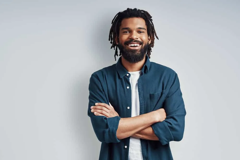 How To Get Dandruff Flakes Out Of Dreadlocks: DIY Step-by-Step 5 A black man with a 4B hair type and dreadlock dandruff that he treated with tea tree oil.