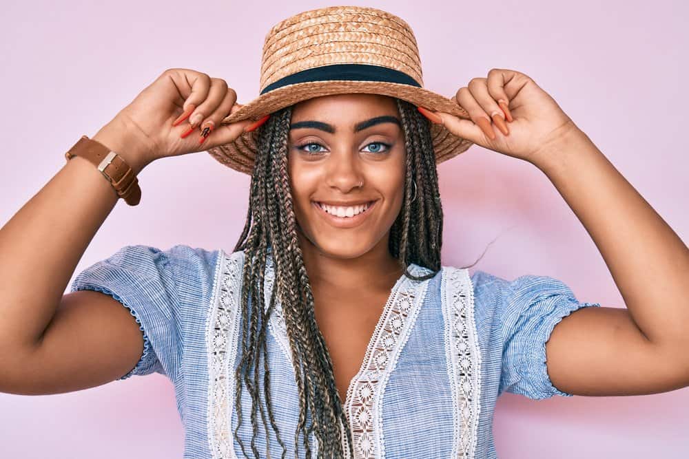 A young African American female wearing individual passion twists on a rough curly texture.