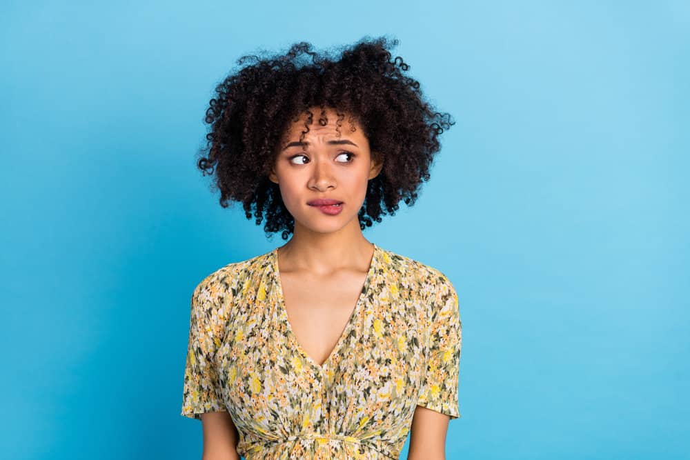 An attractive young African American female with color-treated hair wearing a wash-and-go style.