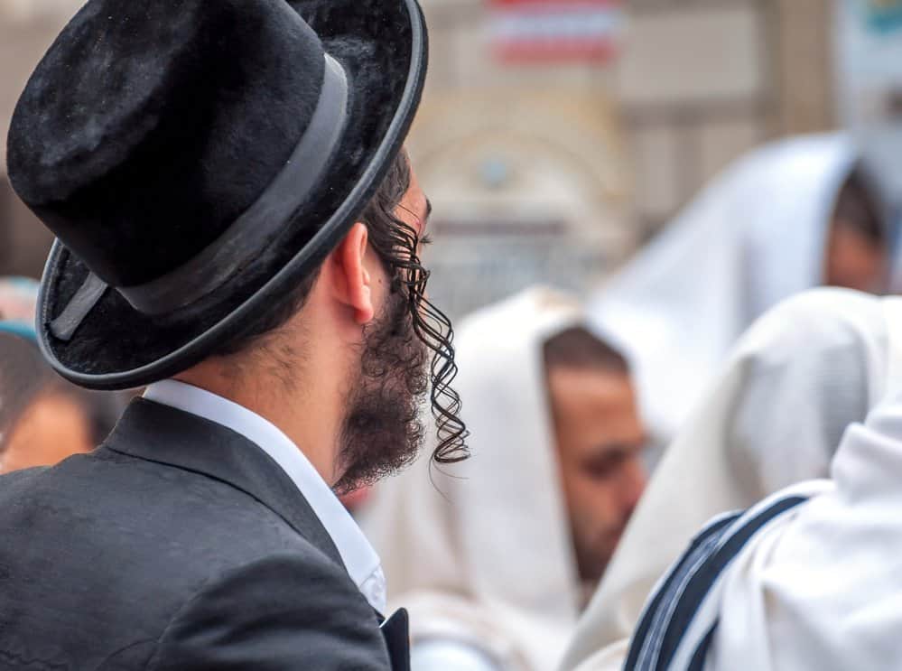 An adult Hasid in a traditional hat-wearing curls - a universal Jewish trait.