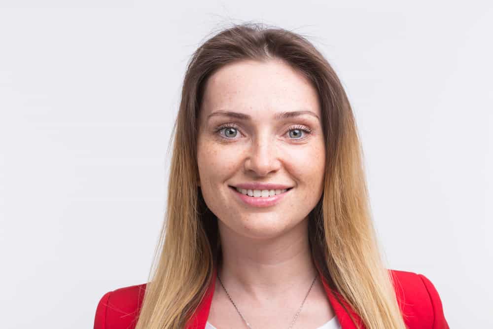 Married woman with uncovered hair wearing a bright red business suit.