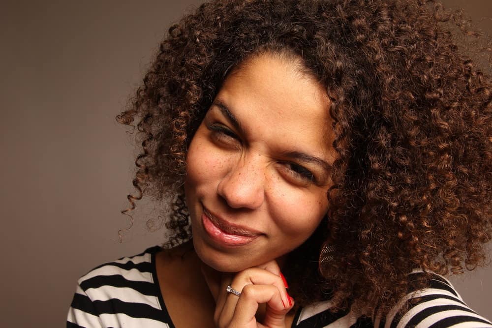 A black girl that's starting to see a gray hair or two is planning to use an old hair dye to color her curls light blonde.