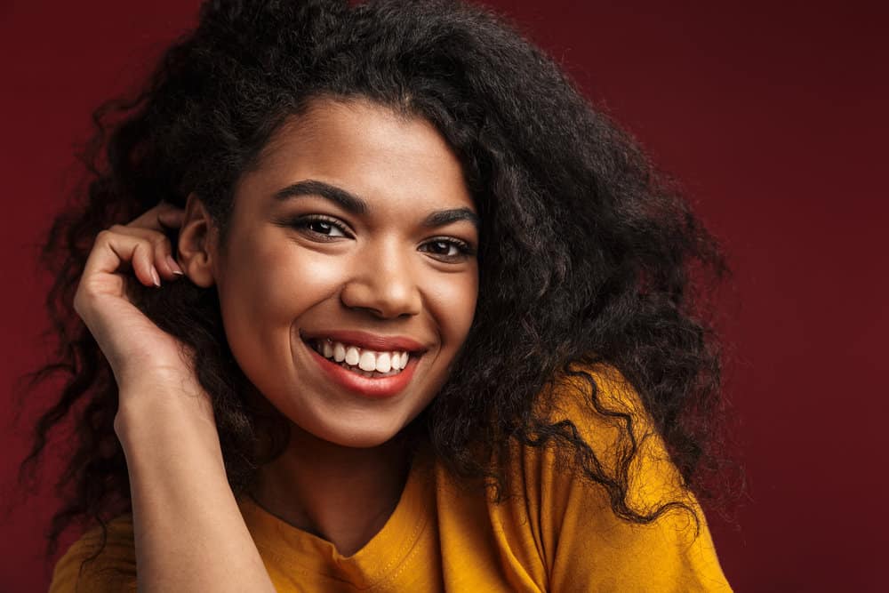 Light-skinned black girl with previously straightened hair styled with a fine-tooth comb and light-hold hairspray.