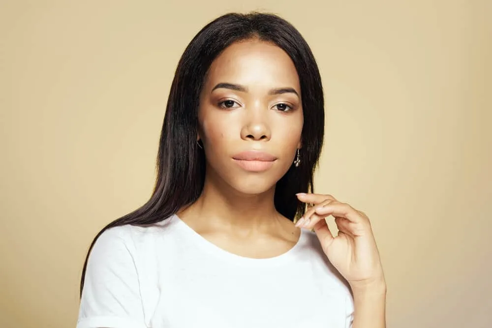 How Long Does Heat Protectant Last on Hair After Applying It? 2 A young light-skinned girl with dry hair after flat ironing her damp hair with a wet-to-dry heated tool.