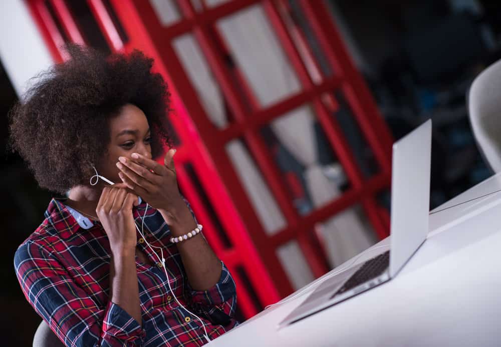 A young African female with a 4C hair type read about whether extra virgin olive oil can help low porosity hair.