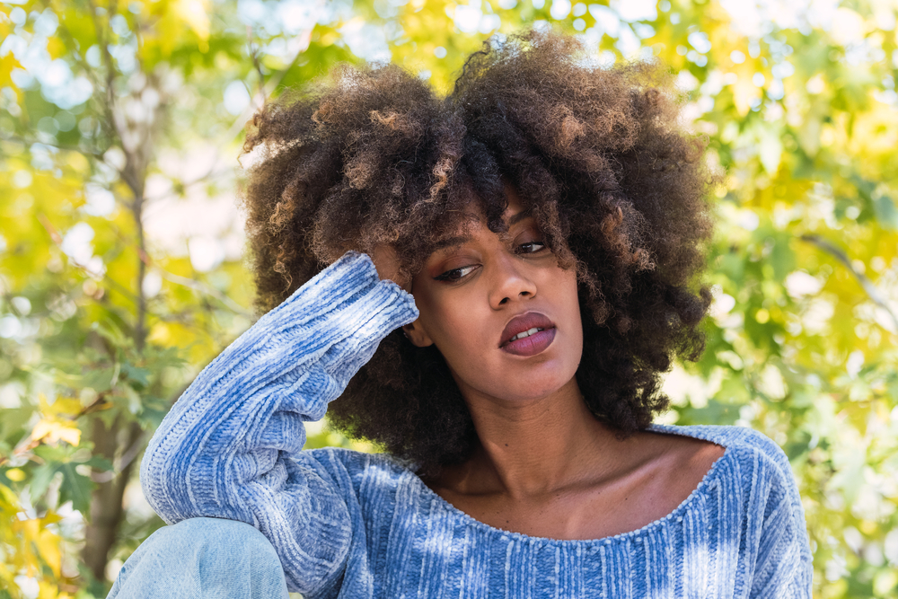 Cute African American that's been using rice water rinses for months to help her hair retain moisture.