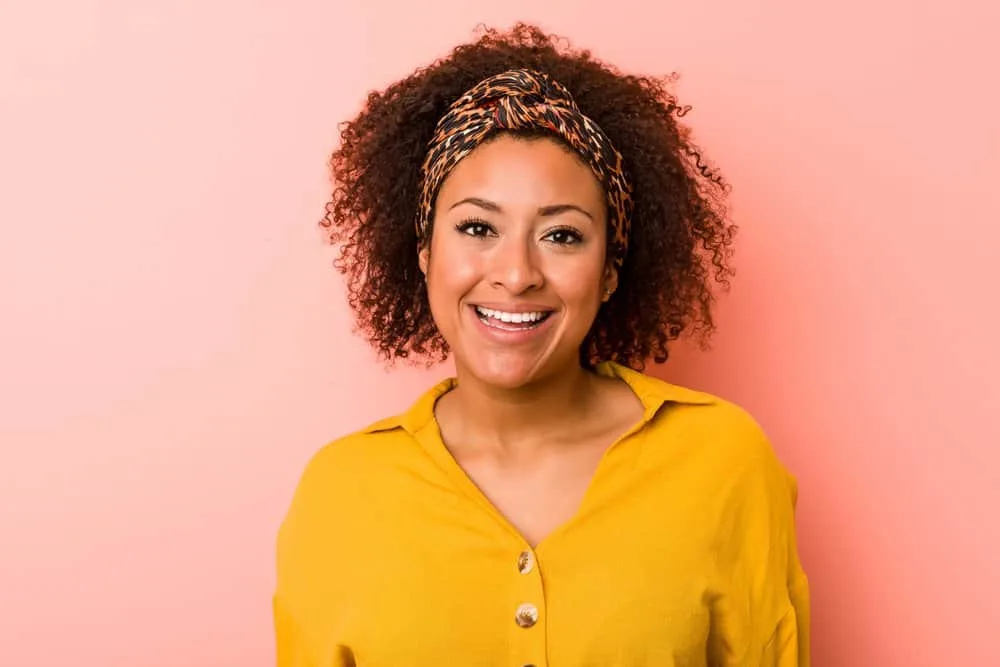 How to Get Splat Hair Dye Off Your Skin: DIY Step-by-Step 3 A young black lady that removed semi-permanent hair dye from her skin using hydrogen peroxide and a cotton ball.