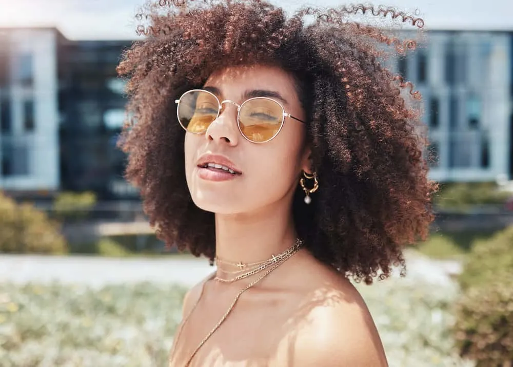 Does Shea Moisture Cause Hair Loss? Is It Good or Bad for Your Hair? 3 African American lady with thick hair and oily skin used the best Shea Moisture shampoo to wash her dyed curls.